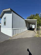 View of side of property with a carport