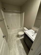 Full bathroom with shower / washtub combination, vanity, and toilet