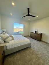 Carpeted bedroom with ceiling fan