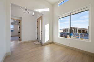 Entrance foyer featuring plenty of natural light and light hardwood / wood-style floors