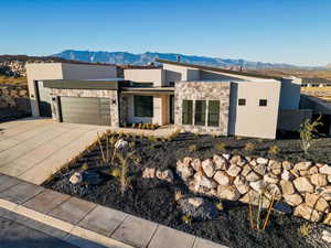 View of front facade with a mountain view and a garage