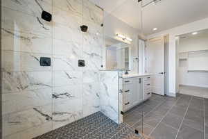 Bathroom with vanity and tiled shower