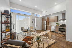 Living room with sink, a healthy amount of sunlight, and light wood-type flooring