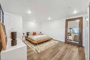 Bedroom featuring wood-type flooring