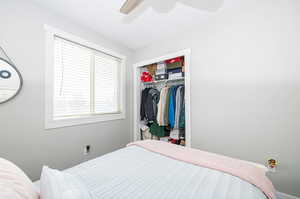 Bedroom with ceiling fan and a closet