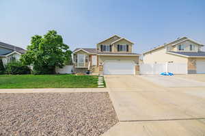 View of front of house featuring a front yard and a garage