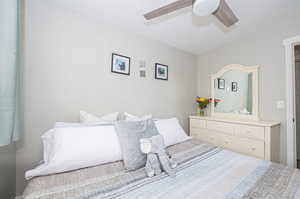 Bedroom with a textured ceiling and ceiling fan