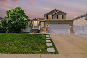 View of front of house featuring a yard and a garage