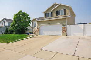 View of front of home featuring a front yard and a garage