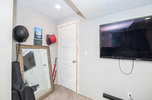 Interior space with carpet and a textured ceiling