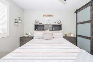 Bedroom featuring a barn door