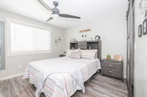 Bedroom with light hardwood / wood-style flooring and ceiling fan