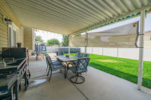 View of patio with a storage shed