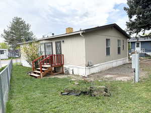 Exterior space featuring a front yard, fence, and a chimney