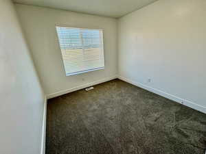 Unfurnished room with carpet flooring