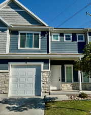 View of front of property featuring covered porch and a garage