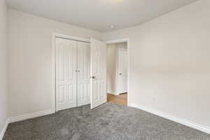 Unfurnished bedroom with carpet floors and a closet