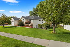 View of front of home featuring a garage and a front lawn