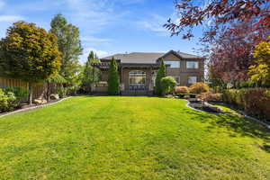 View of Rear Elevation of house from private backyard w/ matured landscaping.