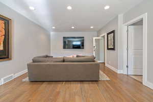 Living room featuring light wood-type flooring and a textured ceiling