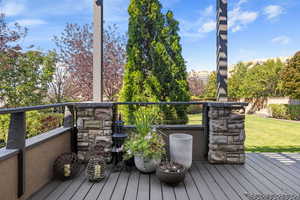 Rear deck overlooking secluded backyard with matured landscaping.