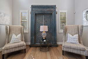 Living Room off of entryway foyer w/ hardwood flooring, plantation shutters & recessed lighting.