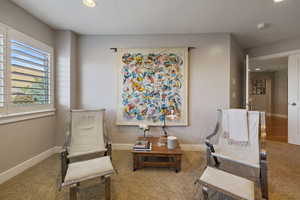 Separate sitting/lounge nook off of Primary Bedroom w/ large windows & plantation shutters.