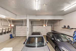 Extra height 3-Car Garage w/ wall mounted storage system & garage openers.