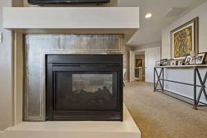 Multi-sided gas fireplace separating Primary Bedroom from sitting/lounge nook.