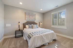 Guest Bedroom #6 w/ light carpet flooring, recessed lighting & plantation shutters.