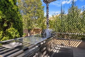 Luxury s.s. & granite countertop bbq/grill outdoor kitchen on back deck w/ mountain bench views.