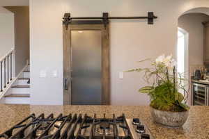 Custom distressed wood & iron metal pantry barn door w/ frosted center glass panel.