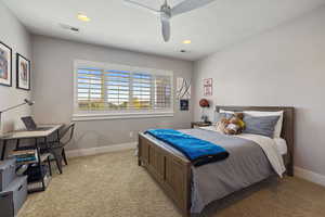 Guest Bedroom #3 w/ light carpet flooring, celing fan, recessed lighting & large windows w/ plantation shutters.