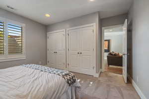 Guest Bedroom #6 w/ light carpet flooring, recessed lighting, plantation shutters & large double doored closets.