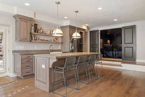 2nd full kitchen w/ granite countertop breakfast bar, Viking s.s. appliances, custom pendant light fixtures & hardwood flooring throughout.