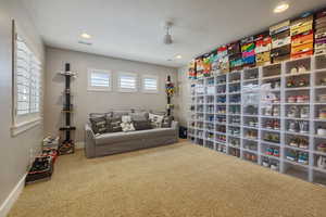 Guest Bedroom #4 w/ light carpet flooring, ceiling fan, recessed lighting & windows w/ plantation shutters.