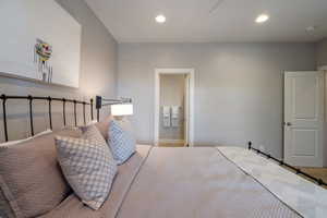 Main floor guest bedroom w/ full ensuite bathroom, recessed lighting & light carpet flooring.