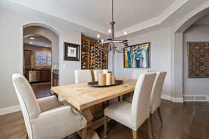 Formal Dining area w/ open archway view into kitchen & hardwood flooring throughout.