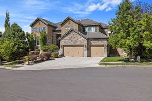 Exterior front facade of house w/ 3-Car Garage & matured landscaped yard.