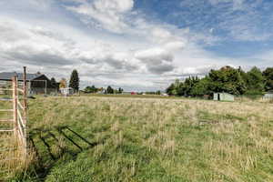 View of yard featuring a rural view and an outbuilding