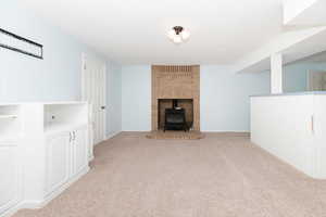 Living room with a gas stove and light colored carpet