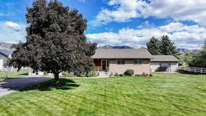 View of front of property featuring a front lawn and a mountain view