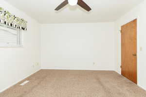 Bedroom featuring ceiling fan and carpet floors