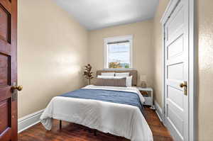 Bedroom with dark wood-type flooring