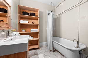 Bathroom featuring independent shower and bath, sink, and tile patterned floors