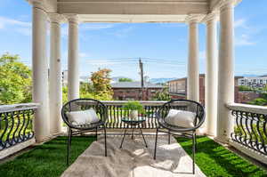 View of patio with a balcony