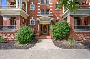 View of exterior entry featuring a balcony