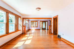 Unfurnished room featuring light hardwood / wood-style flooring and plenty of natural light