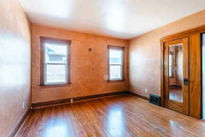 Empty room with a healthy amount of sunlight and wood-type flooring