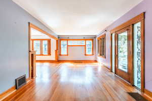 Unfurnished living room with a healthy amount of sunlight and light hardwood / wood-style flooring